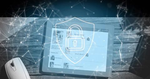 Tablet cybersecurity concept shield lock overlay with network nodes and mouse on wooden desk