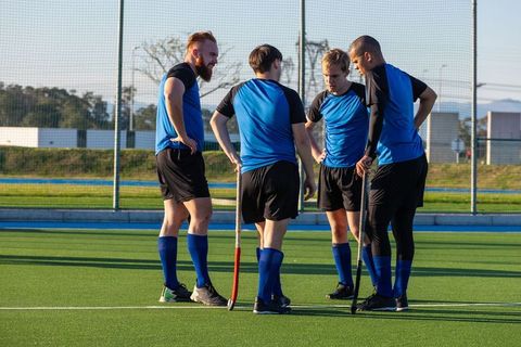 Youthful Hockey Team Discussing Strategy on Field