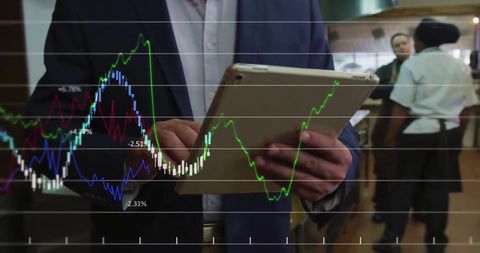 Professional Analyzing Financial Data on Digital Tablet