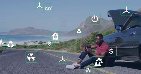 Man Relaxing Next to Car on Scenic Coastline with Modern Technology Icons