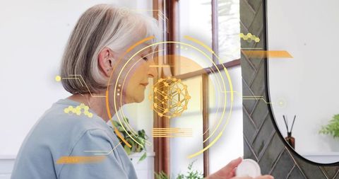 Elderly woman examining skincare jar with augmented reality mirror overlay and digital hud