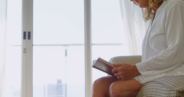 Senior Woman Sitting and Reading Book at Home - Download Free Stock Images Pikwizard.com