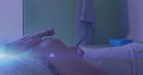Comforting Hands of Caregiver on Hospital Patient's Hand with Blue Light Streaks