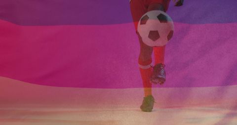 Football player kicking ball with german flag overlay