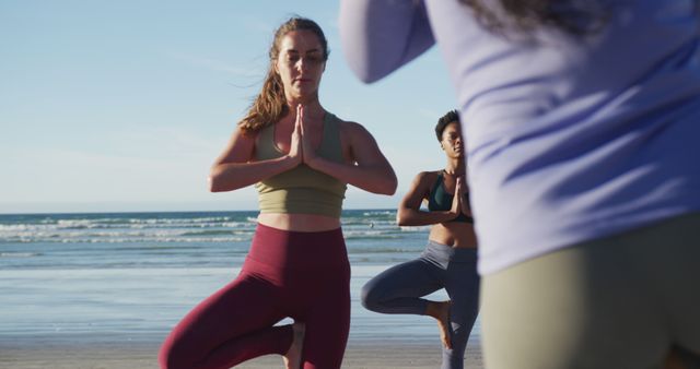 Woman practicing yoga on the beach, Woman practicing yoga o…