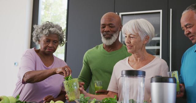 Diverse senior friends making healthy smoothies together in kitchen - Download Free Stock Images Pikwizard.com