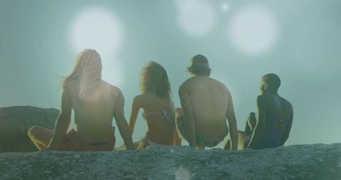 Friends Enjoying Sunny Day Together on Rock Ledge