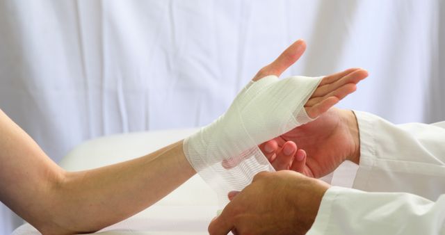 Doctor Wrapping A Patient's Injured Hand With Bandage - Download Free Stock Images Pikwizard.com