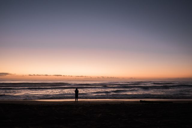 Person Standing Near the Shore during Sunset - Download Free Stock Photos Pikwizard.com