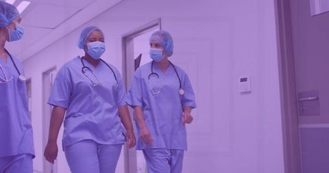 Healthcare Professionals Walking in Hospital Corridor in Surgical Scrubs