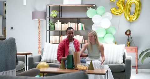 Couple Enjoying Birthday Celebration at Home with Gifts
