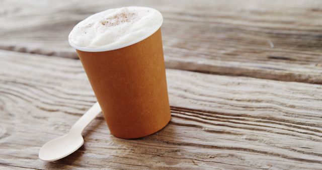 Cup of frothy coffee on wooden table - Download Free Stock Images Pikwizard.com