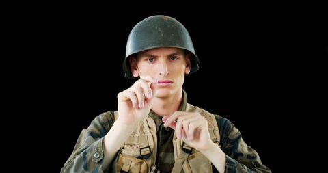 Army Soldier Interacting with Virtual Interface on a Black Background