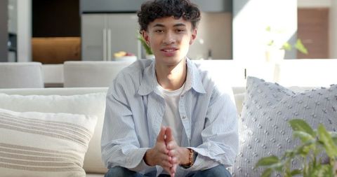 Young Man Relaxing in Modern Living Room with Minimalistic Design
