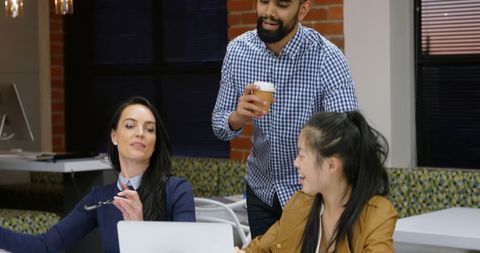 Team Collaboration in Modern Office Setting with Smiling Coworkers