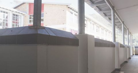 School Corridor with Tiled Walkway and Metal Roof Structure