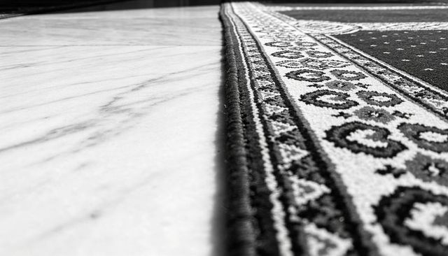 Diagonal rug border on marble floor showing woven texture, binding and seam