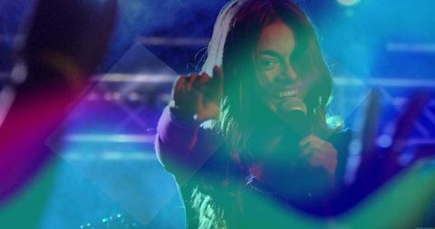 Dynamic Female Singer Performing under Vibrant Stage Lights