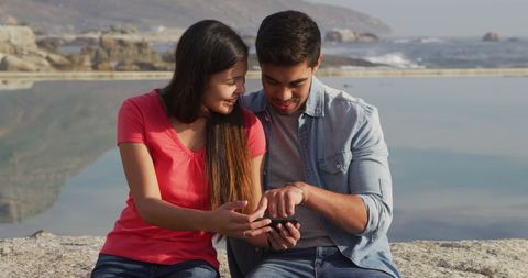 Happy Couple Relaxing by Sea and Using Smartphone - Download Free Stock Images Pikwizard.com