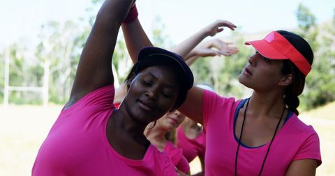 Female Trainer Guiding Women at Outdoor Boot Camp