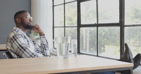 Man relaxing at workplace with hydration and scenic view