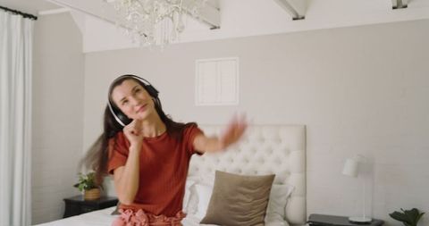 Woman Enjoying Music on Bed in Modern Bedroom