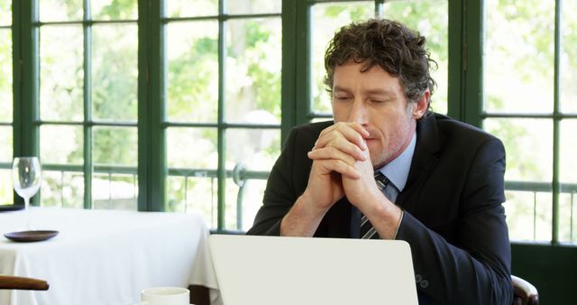 Businessman Pondering at Work Desk by Large Windows - Download Free Stock Images Pikwizard.com