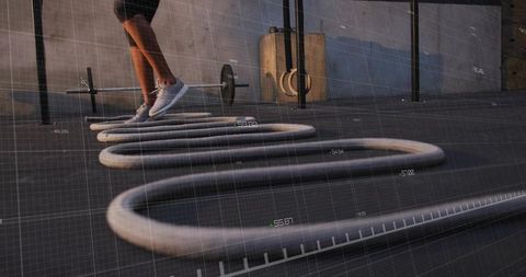 Woman Training with Battle Ropes for Agility and Fitness in Gym