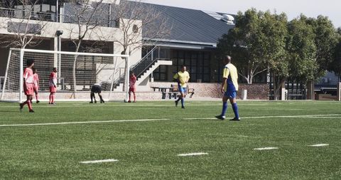 Youth soccer team preparing for penalty kick during school match