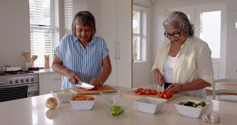 Senior Women Cooking Together in Bright Modern Kitchen