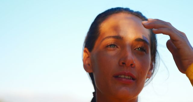 Woman Touching Her Hair and Enjoying Sunshine Outdoors - Download Free Stock Images Pikwizard.com