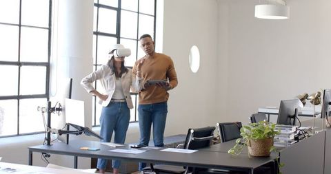 Woman using vr headset collaborating in modern office