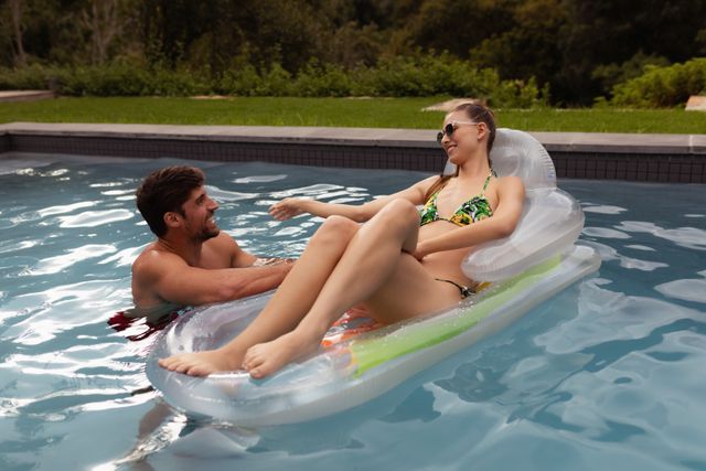 Couple having fun together in swimming pool - Download Free Stock Photos Pikwizard.com