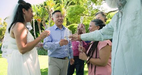 Diverse senior wedding gathering celebrating with champagne toast