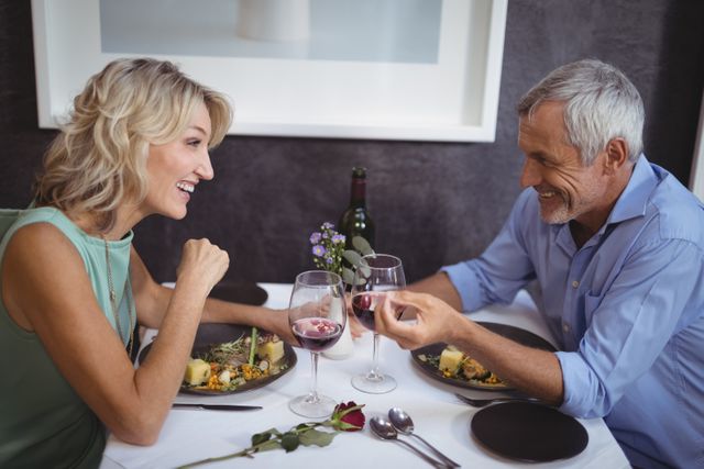 Mature couple interacting with each other in restaurant