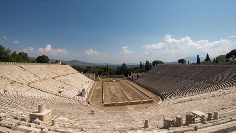 Panoramic Ancient Roman Amphitheatre with Stone Seating and Central Arena on Hilltop