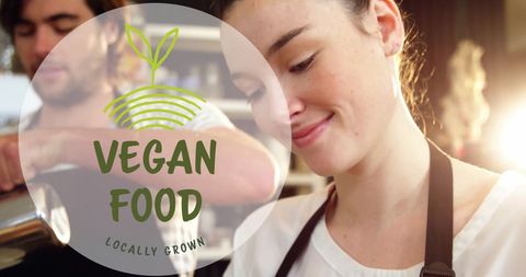 Smiling barista promoting locally grown vegan lifestyle