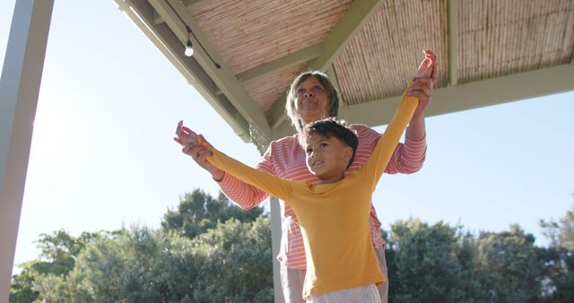 Happy Grandmother and Boy Playfully Stretching Outdoors - Download Free Stock Images Pikwizard.com