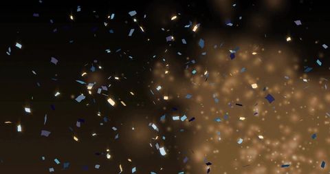 Golden Bokeh and Metallic Confetti Falling over Dark Background for Celebration