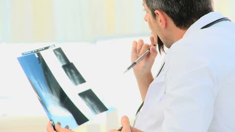 Doctor Analyzing Medical Scan in Clinical Setting