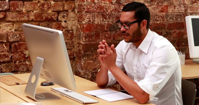 Young Man Working at Desk with Modern Computer in Loft Space - Download Free Stock Images Pikwizard.com