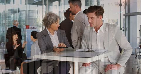 Business Colleagues Discussing Reports with Digital Overlay