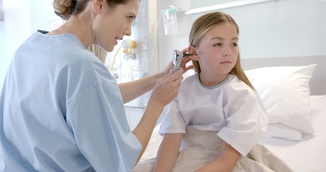 Nurse Checking Young Girl's Ear in Hospital Room - Download Free Stock Images Pikwizard.com