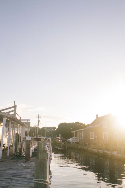 Sunlit Waterfront Dock with Huts - Download Free Stock Images Pikwizard.com