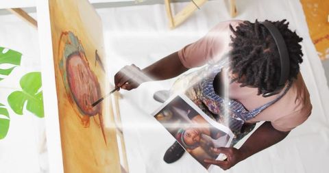 Artist painting with brush in creative studio workspace