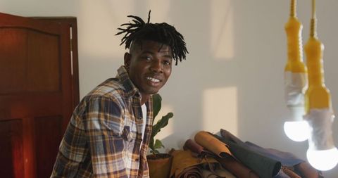 African American Craftsman Smiling at Leather Workshop