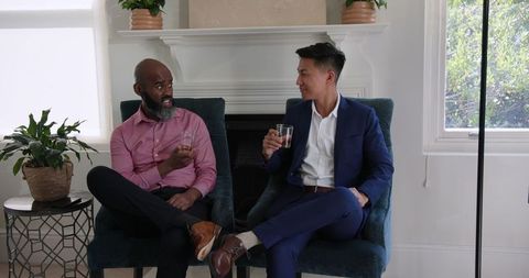 Diverse friends socializing at home in formal attire