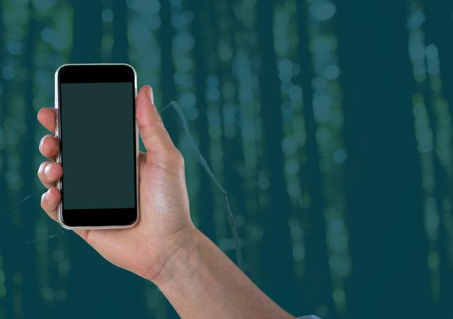 Hand holding smartphone with blank screen and blurred forest background, ideal for showcasing mobile applications, technology in nature, or introductory clips for tech-nature integration videos.
