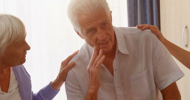 Worried Elderly Man Being Comforted by Friend and Caregiver - Download Free Stock Images Pikwizard.com