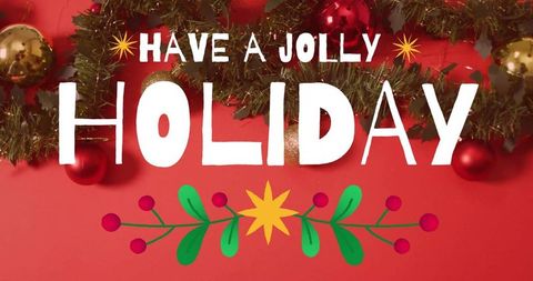Have jolly holiday typography with evergreen garland, gold and red baubles, festive flatlay